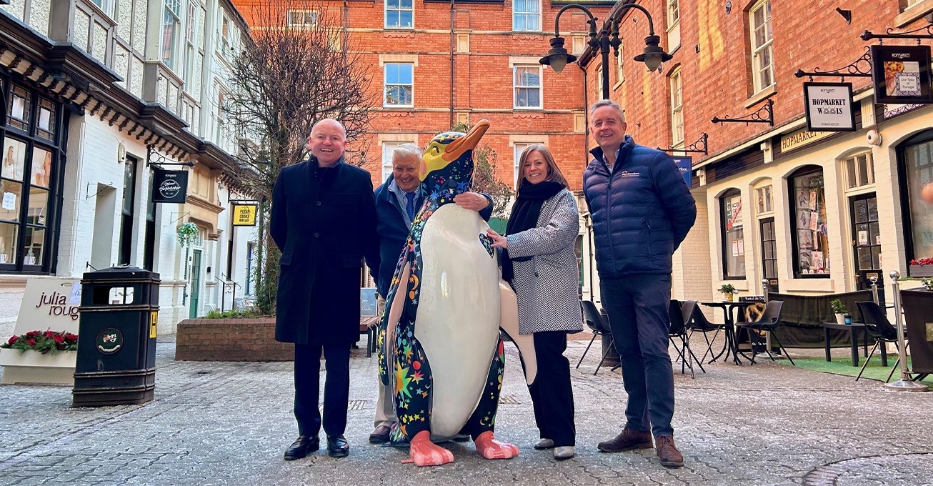 Trio form huddle to support penguin parade